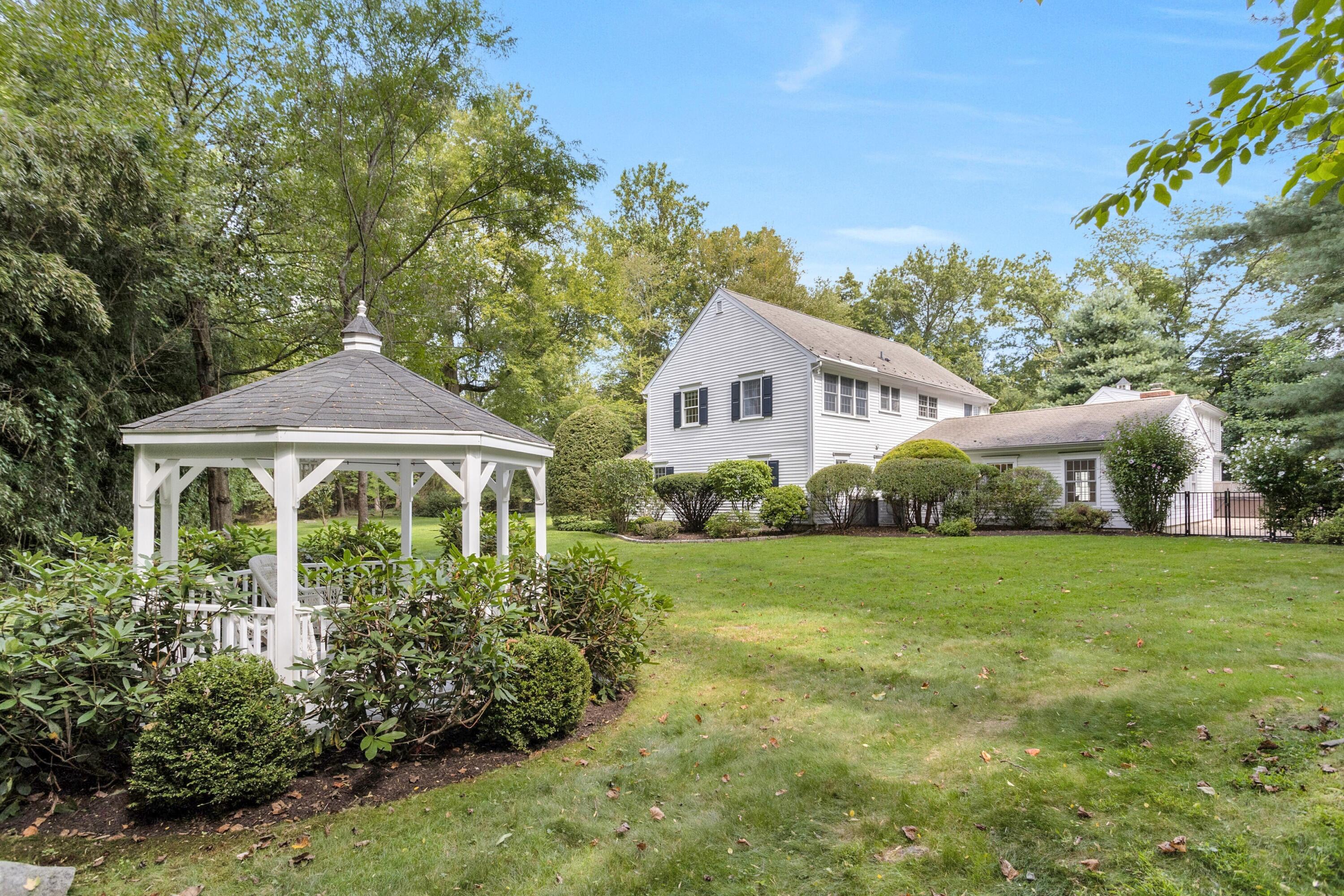 215 Leroy Avenue Darien, CT 06820 - Photo 31 of 34 a front view of a house with a yard and potted plants