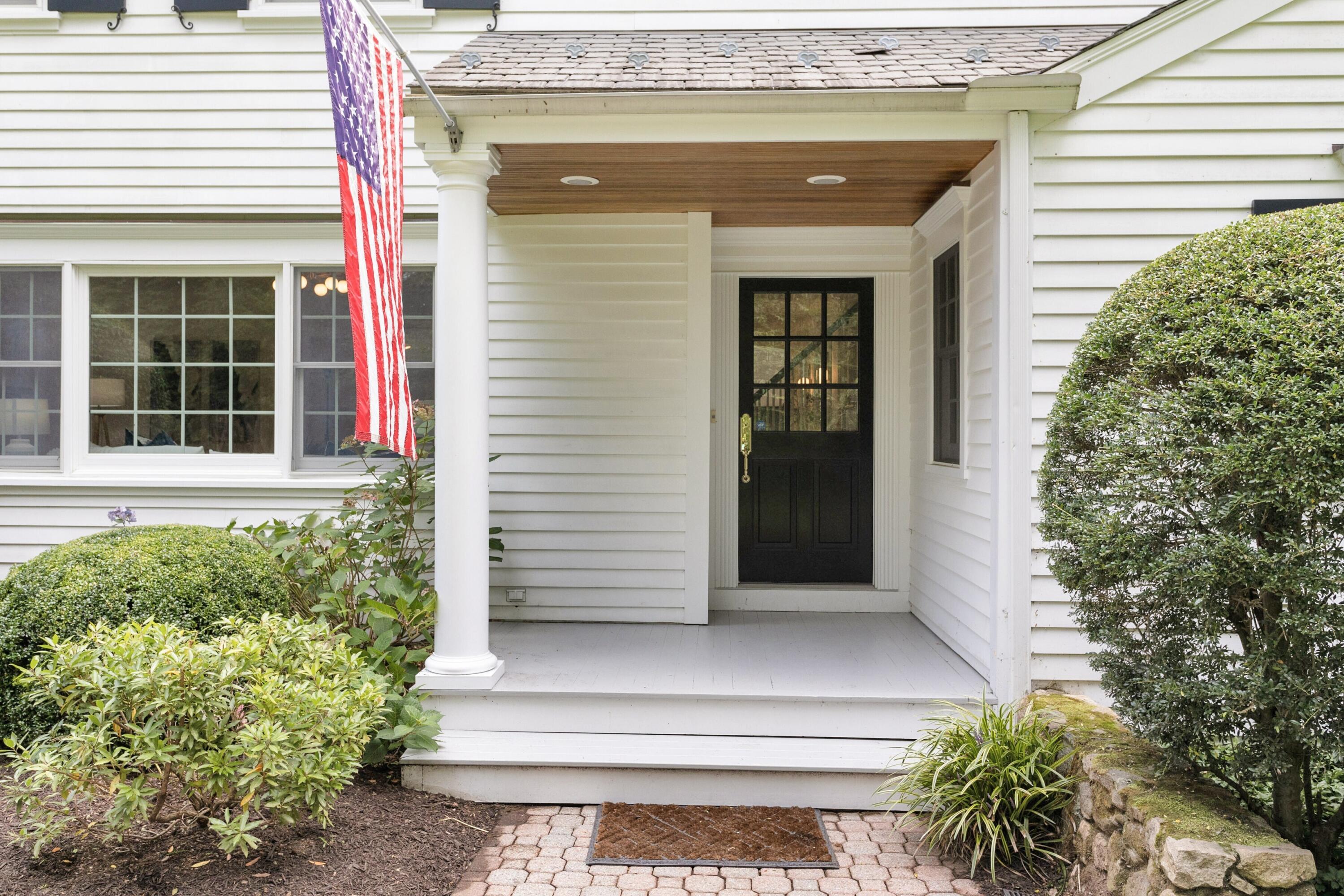 215 Leroy Avenue Darien, CT 06820 - Photo 6 of 34 a house with potted plants in front of door