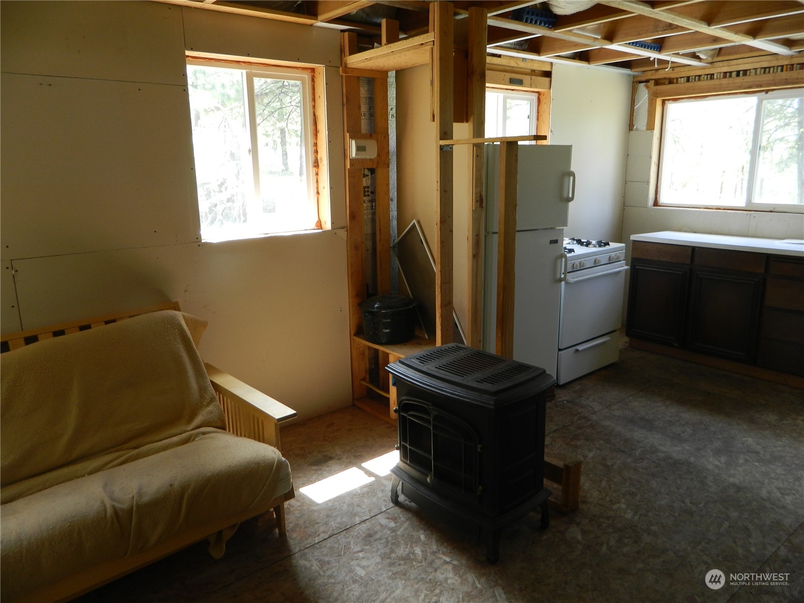 210 Main Road Tonasket, WA 98855 - Photo 11 of 39 a room with a couch and a window