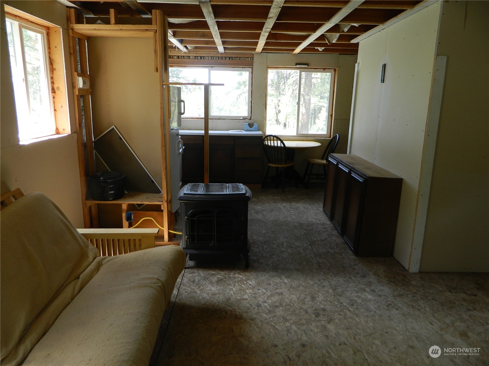 210 Main Road Tonasket, WA 98855 - Photo 12 of 39 a living room with furniture a flat screen tv and a window