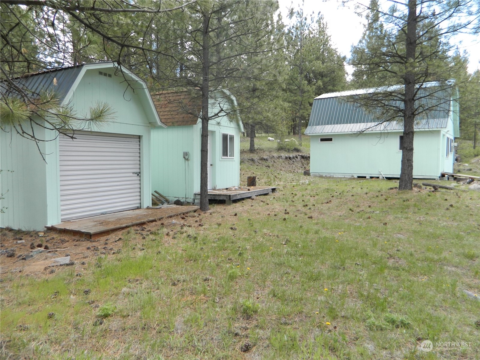 210 Main Road Tonasket, WA 98855 - Photo 6 of 39 a view of a house with a yard