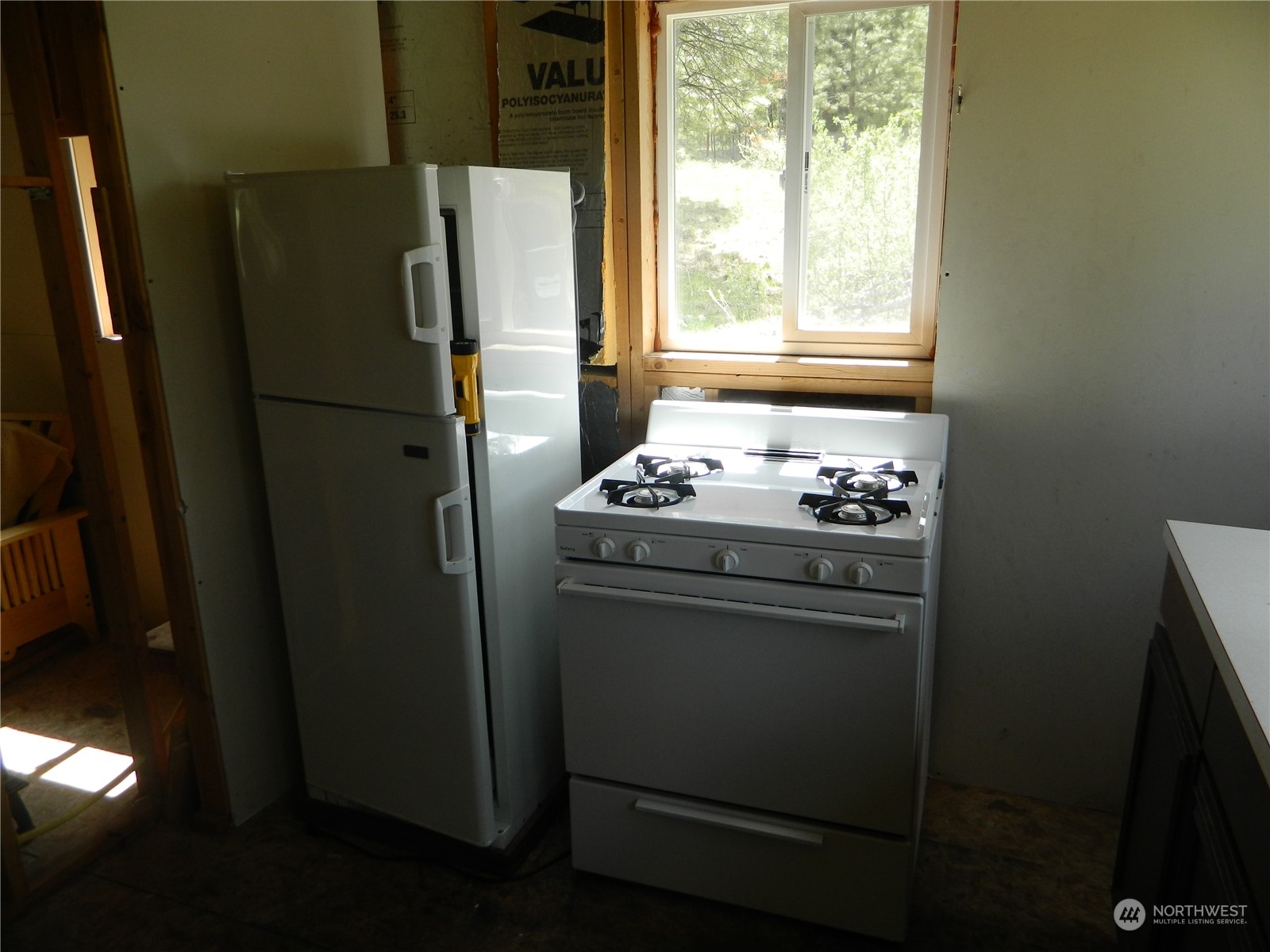 210 Main Road Tonasket, WA 98855 - Photo 9 of 39 a kitchen with stainless steel appliances a refrigerator sink and cabinets