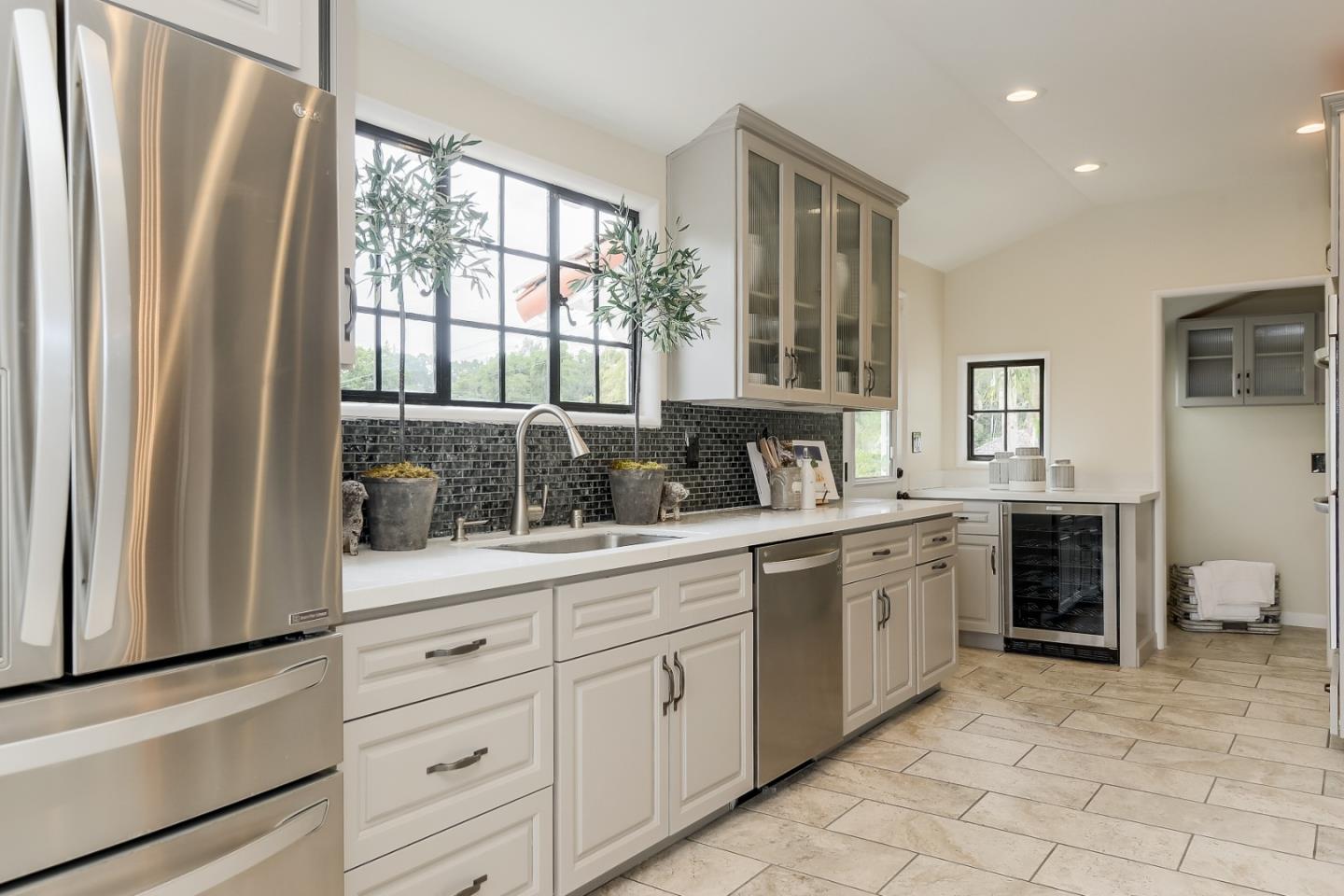 125 Alturas Drive Burlingame, CA 94010 - Photo 29 of 59 a spacious bathroom with a granite countertop sink a mirror a window and a bathtub