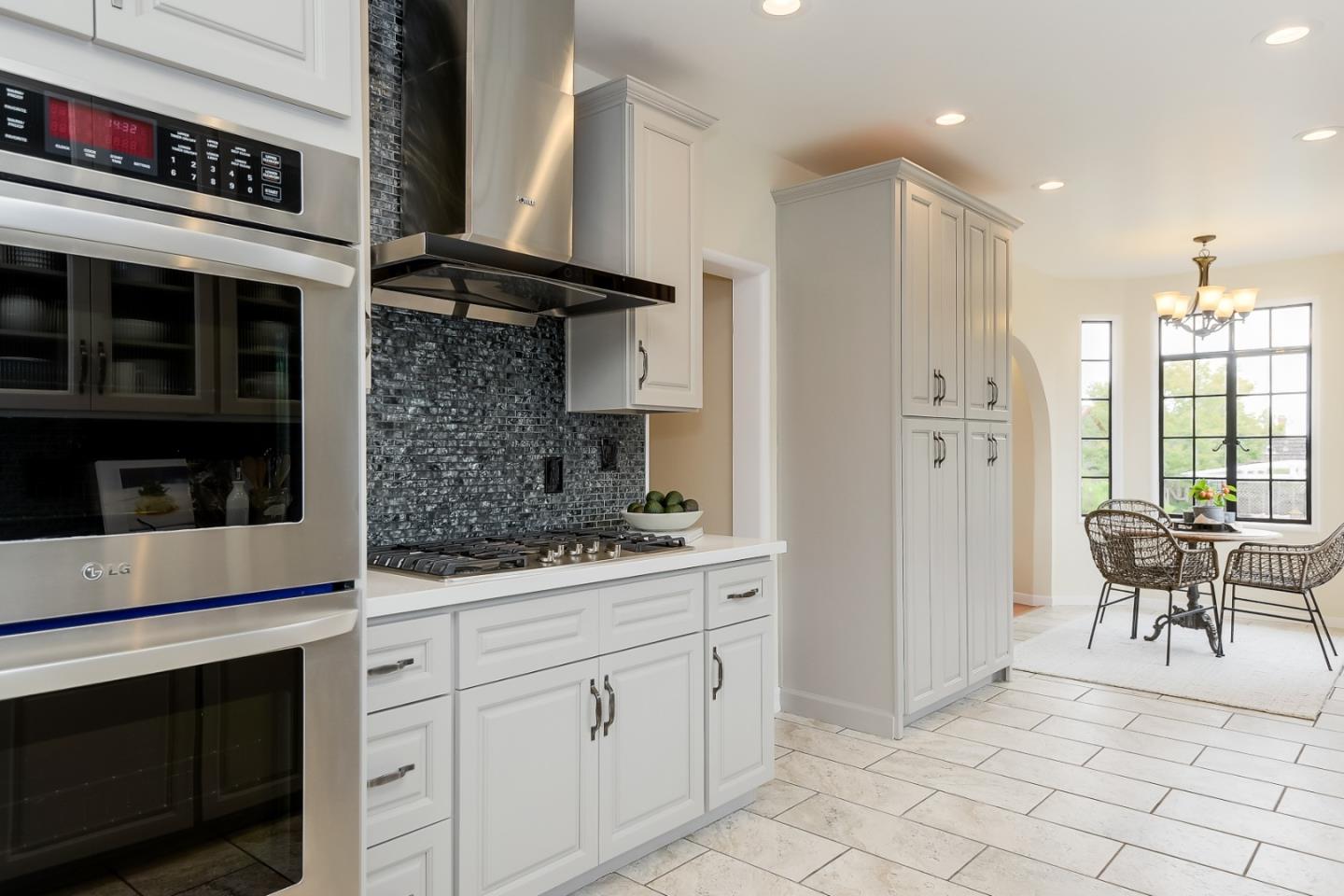 125 Alturas Drive Burlingame, CA 94010 - Photo 31 of 59 a kitchen with white cabinets and appliances