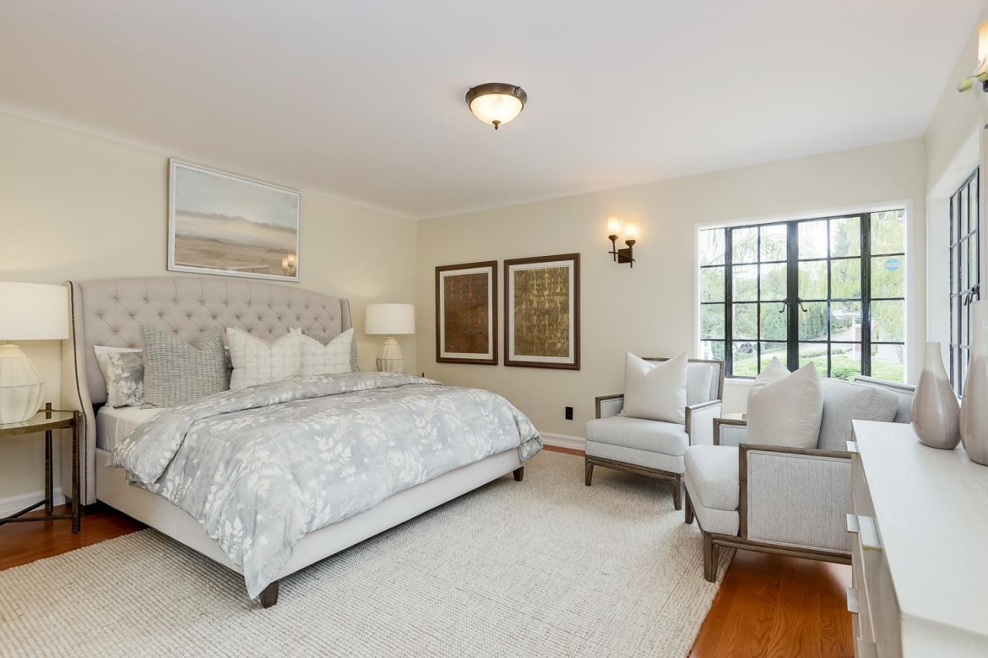 125 Alturas Drive Burlingame, CA 94010 - Photo 34 of 59 a spacious bedroom with a bed and a couch next to a window
