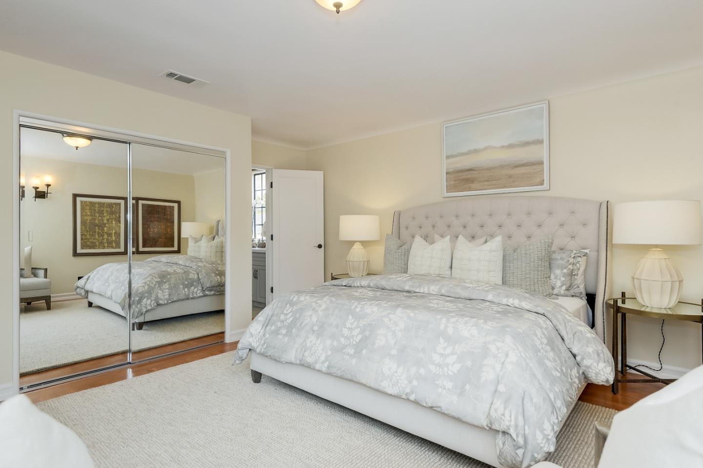 125 Alturas Drive Burlingame, CA 94010 - Photo 35 of 59 a bedroom with a large bed and a chandelier