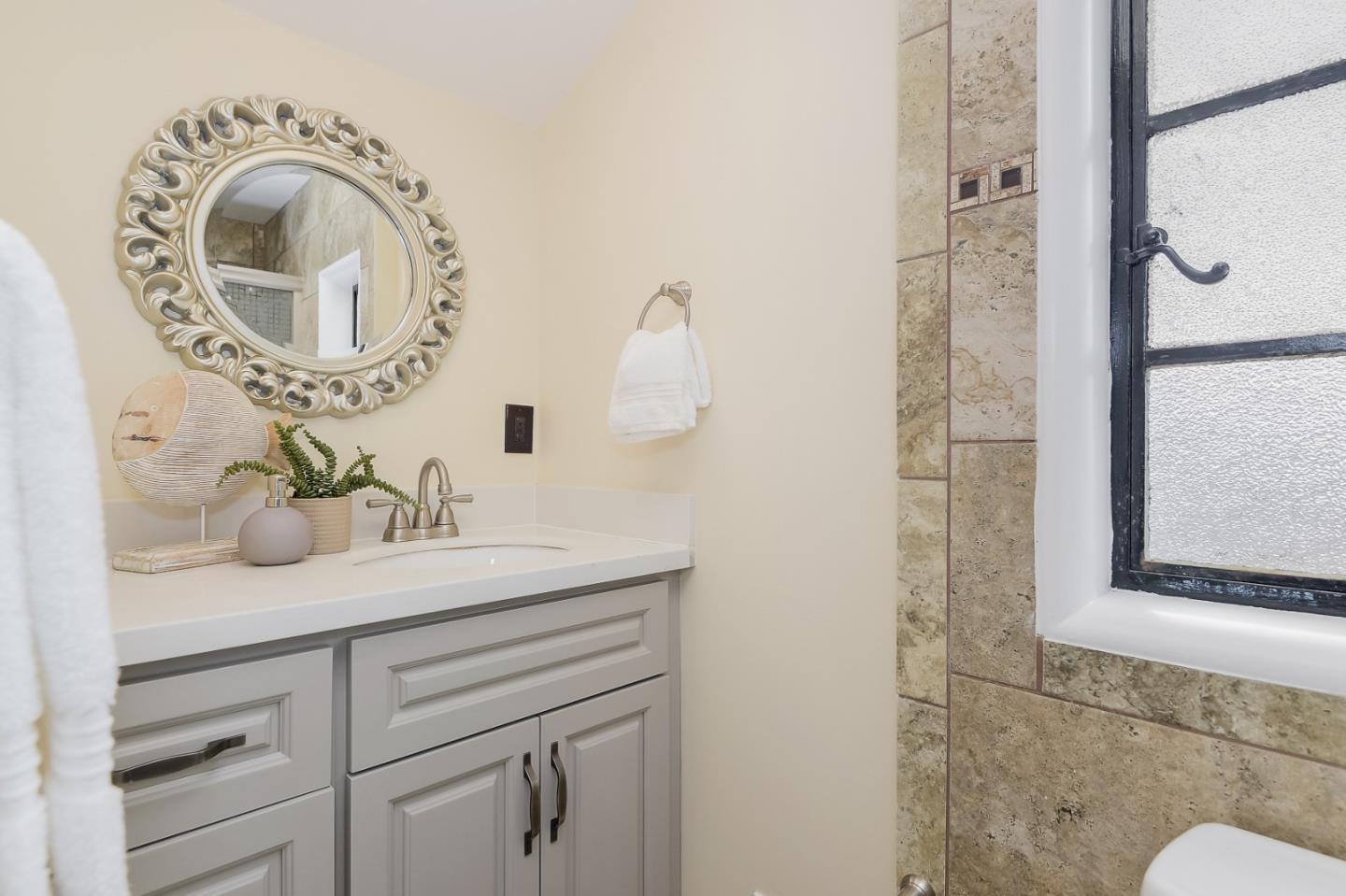 125 Alturas Drive Burlingame, CA 94010 - Photo 40 of 59 a bathroom with a sink and a mirror