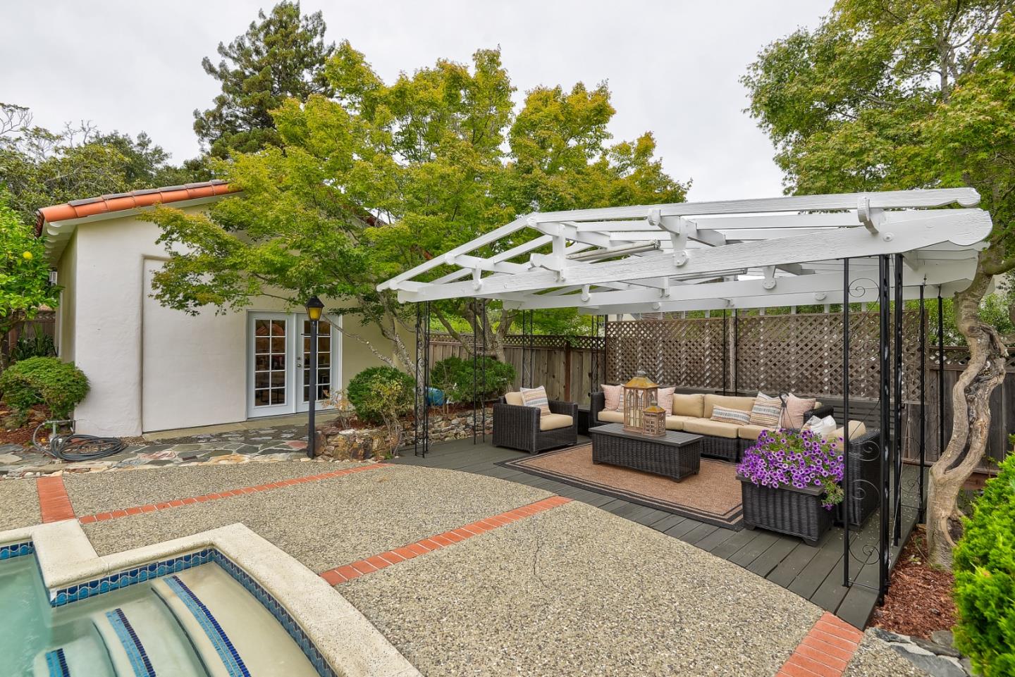 125 Alturas Drive Burlingame, CA 94010 - Photo 54 of 59 a backyard of a house with a garden and outdoor seating