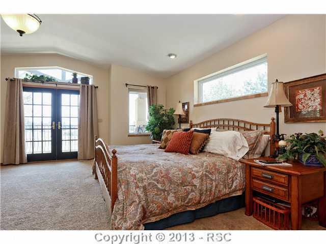 14575 Raton Road Colorado Springs, CO 80921 - Photo 12 of 25 Beautiful french doors lead to a private balcony outside to the front of the home. Relax and enjoy unreal views, mature landscaping and pastures of the Sun Hlls countryside.