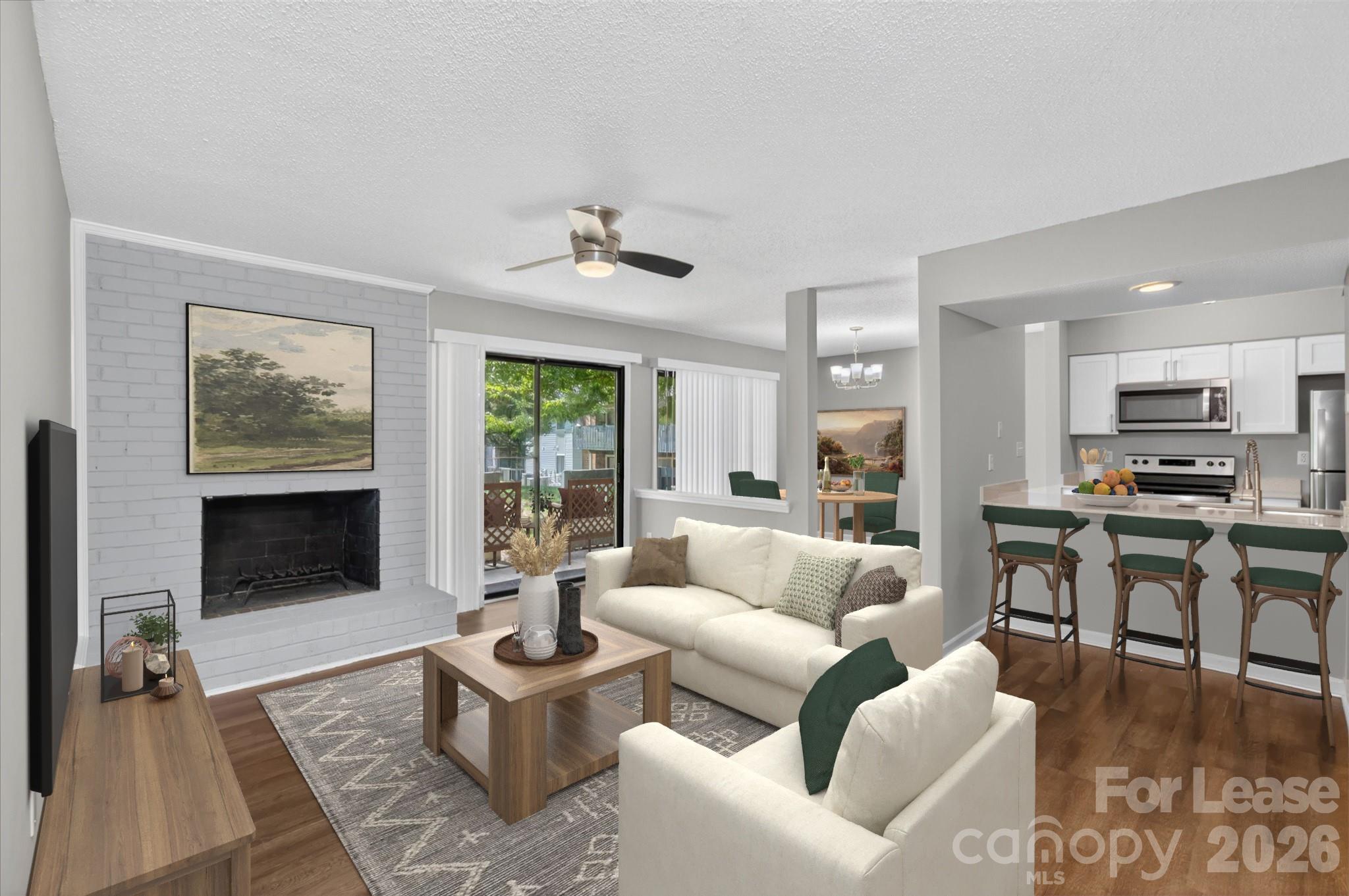 a living room with furniture kitchen view and a fireplace