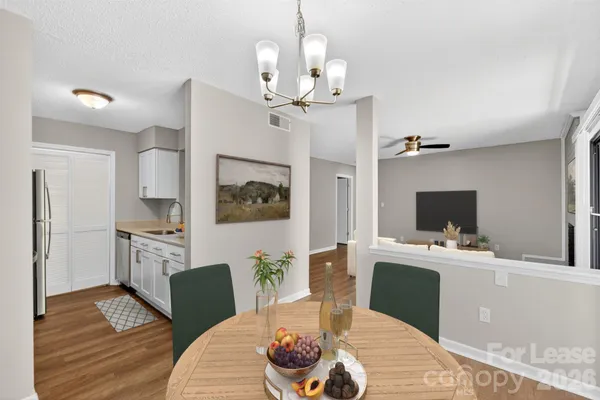 a living room with furniture a dining table and a fireplace