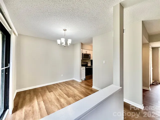 a view of a living room with wooden floor