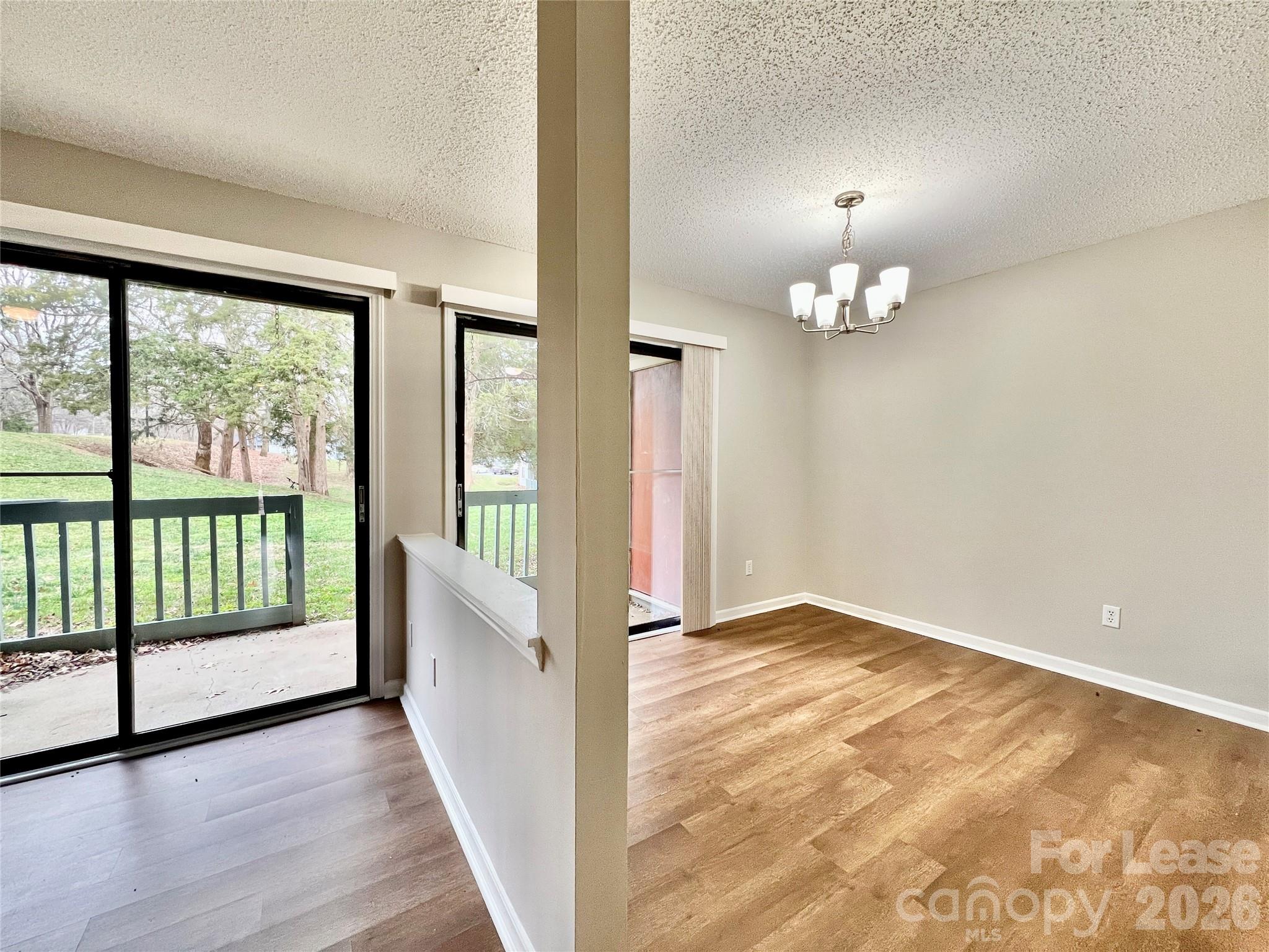 11084 Harrowfield Road Charlotte, NC 28226 - Photo 8 of 31 an empty room with wooden floor and fan