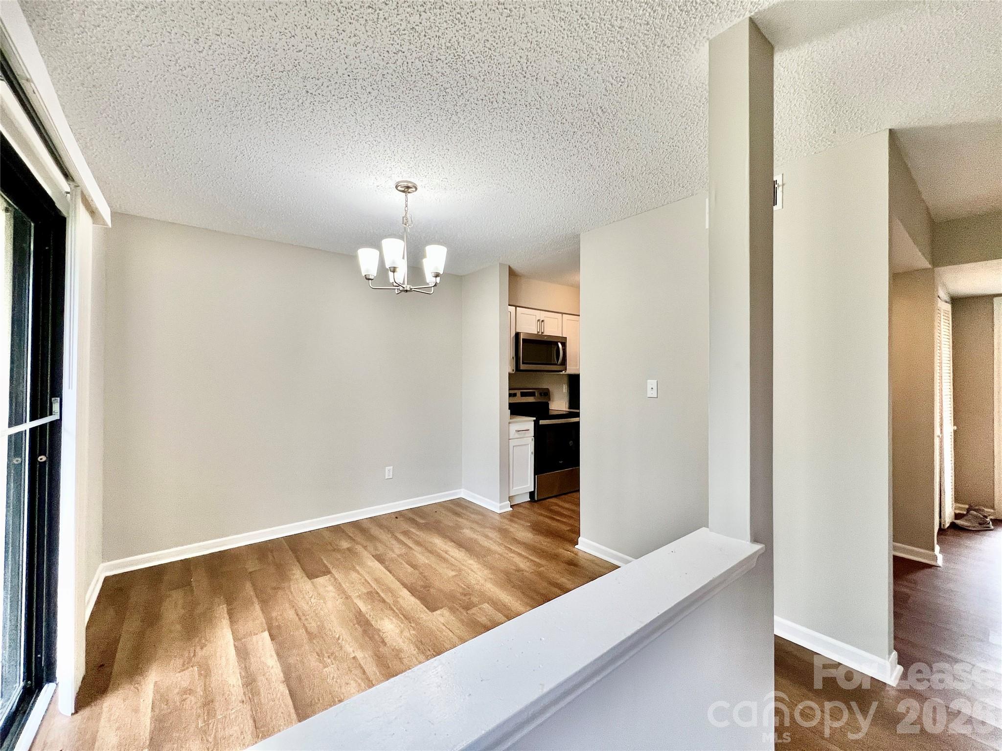 11084 Harrowfield Road Charlotte, NC 28226 - Photo 9 of 31 a view of a living room with wooden floor