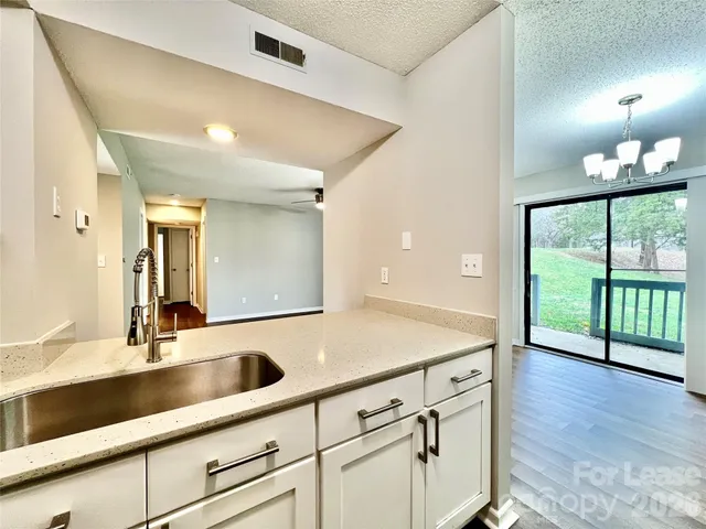 a kitchen with a sink and large window