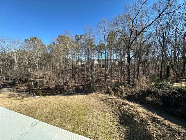 a view of parking with cars parked on road