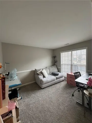 a living room with furniture fireplace and dining table