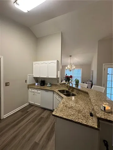 a kitchen with a refrigerator and a stove top oven