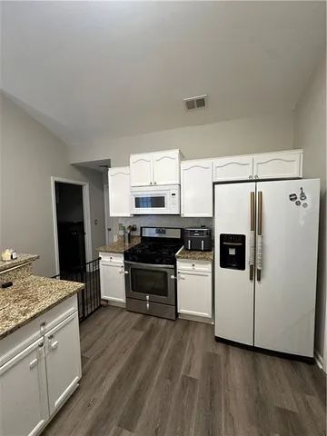 a spacious bedroom with a bed and window