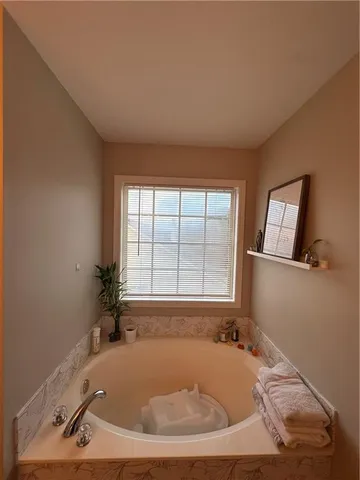 a spacious bedroom with a bed and a window