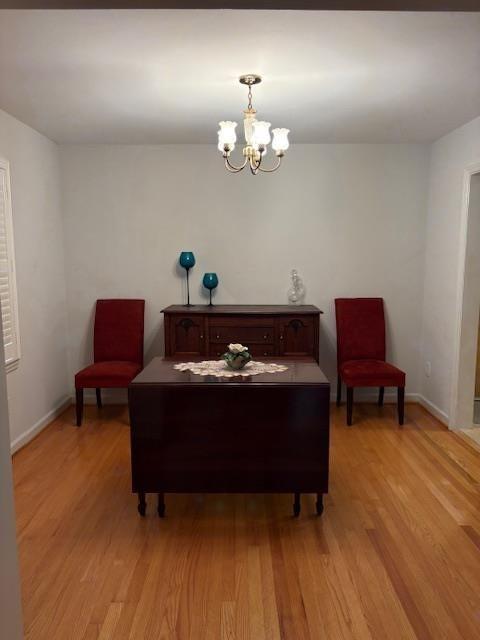 1777 Rosalind Drive Northeast Atlanta, GA 30329 - Photo 12 of 29 a room with a chandelier and a wooden floor