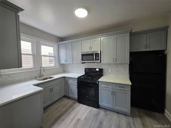 a kitchen with a sink a window and appliances