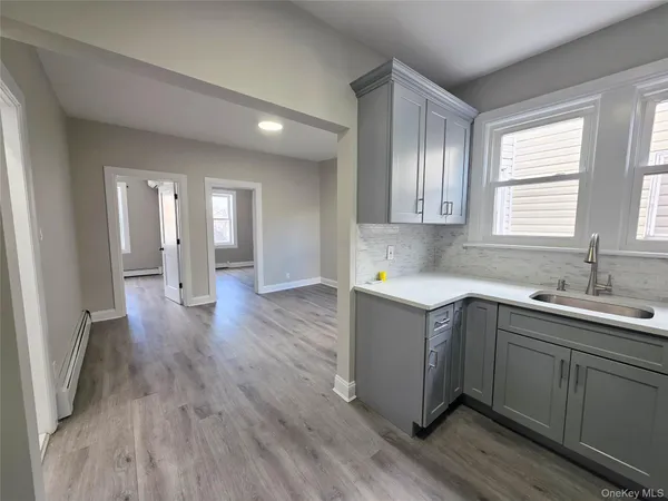 a view of a kitchen sink cabinets and wooden floor