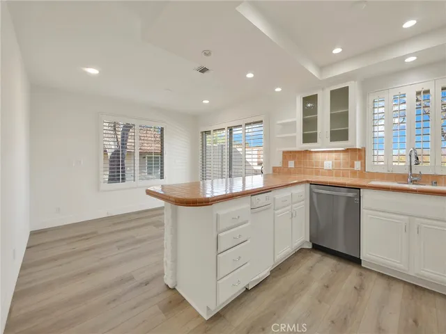 a large kitchen with granite countertop a large window and a sink