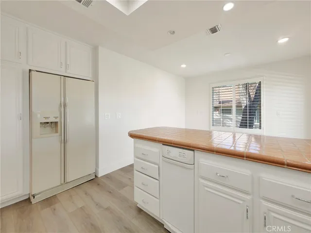 a kitchen with a refrigerator and window