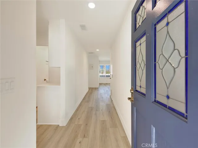 a view of a hallway with wooden floor and staircase