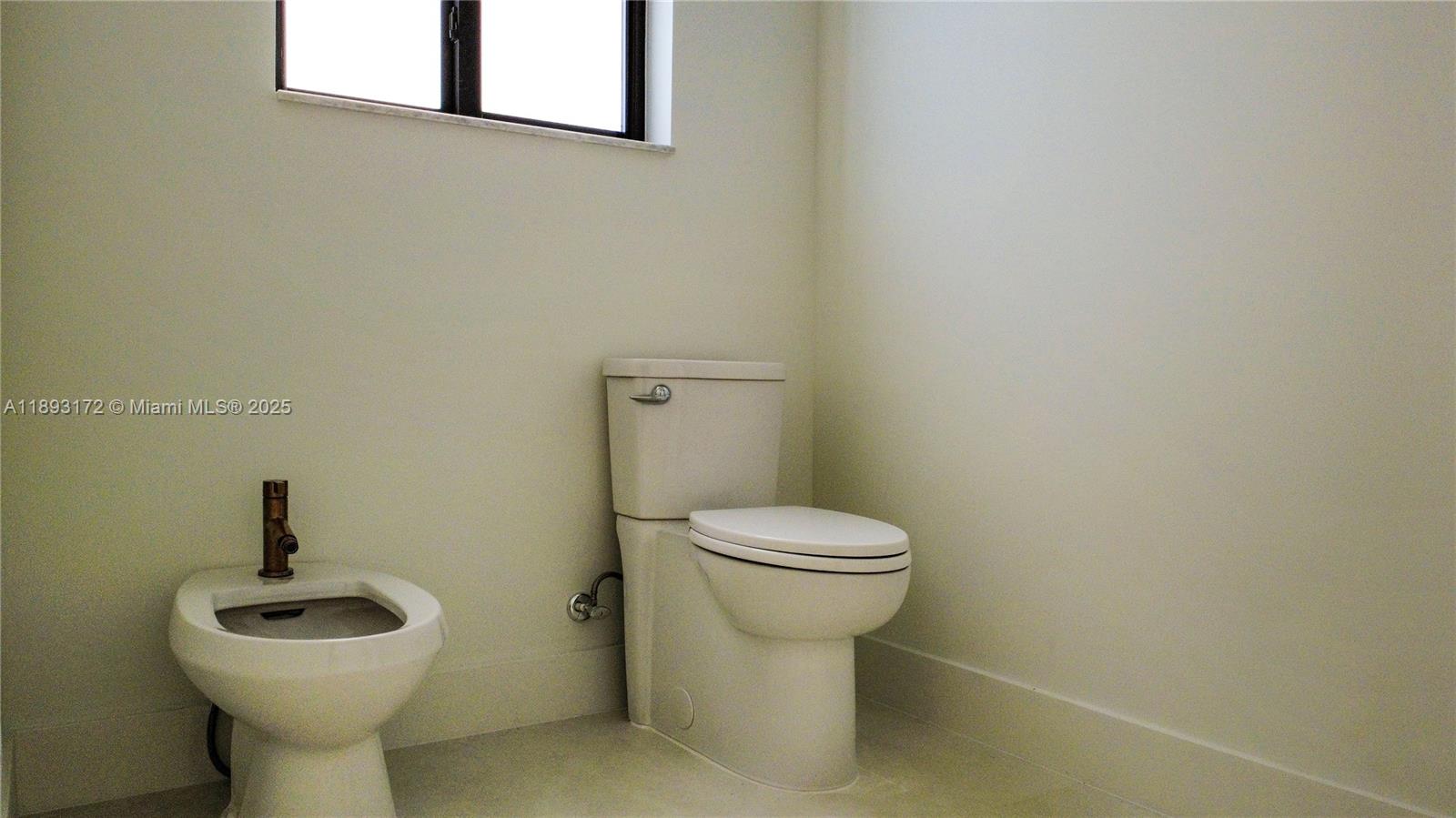 17354 Southwest 287th Street Homestead, FL 33030 - Photo 17 of 22 a bathroom with a toilet sink and mirror