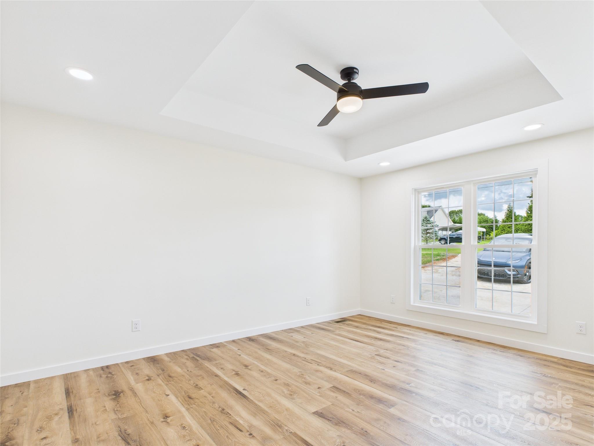 3016 Icard Rhodhiss Road Connelly Springs, NC 28612 - Photo 11 of 20 a view of empty room with wooden floor and fan