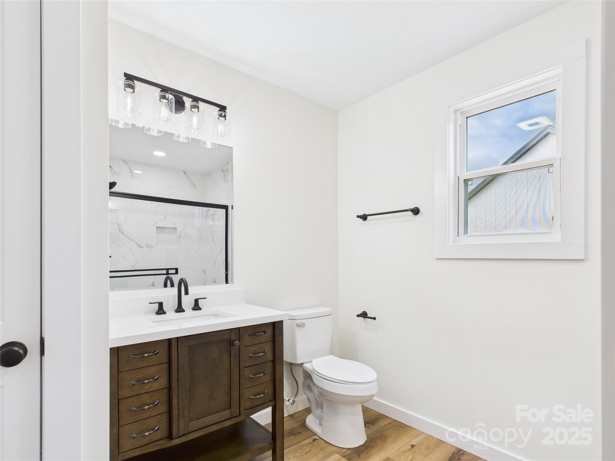 3016 Icard Rhodhiss Road Connelly Springs, NC 28612 - Photo 13 of 20 a bathroom with a toilet sink and mirror