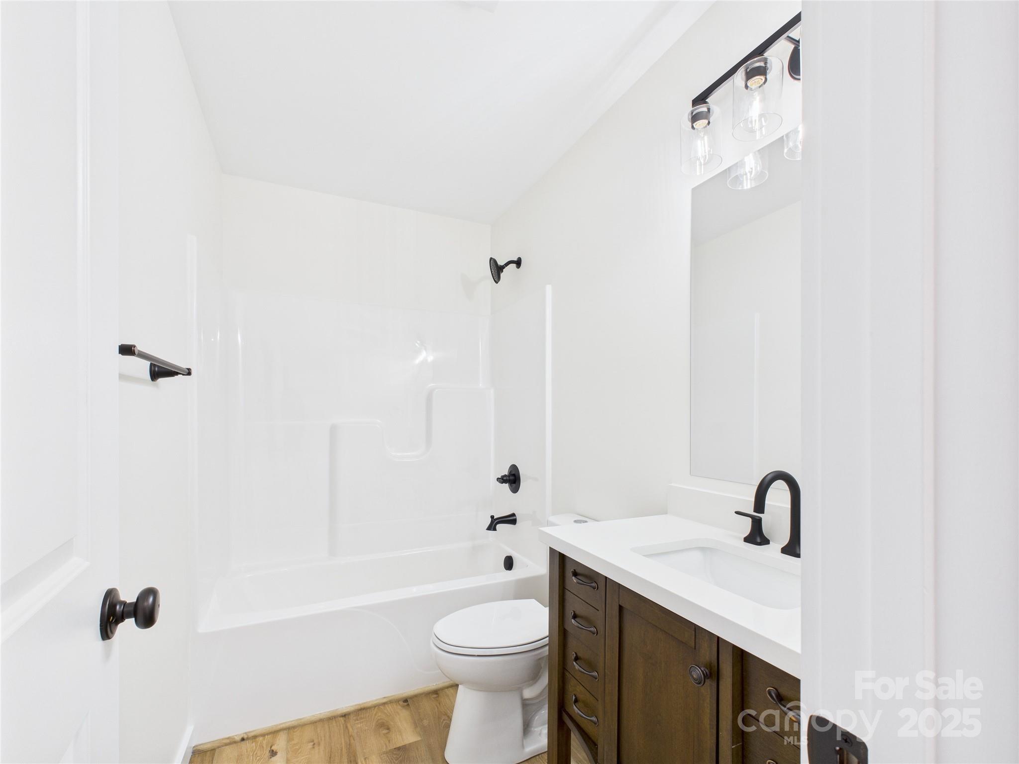 3016 Icard Rhodhiss Road Connelly Springs, NC 28612 - Photo 7 of 20 a bathroom with a sink a toilet and shower