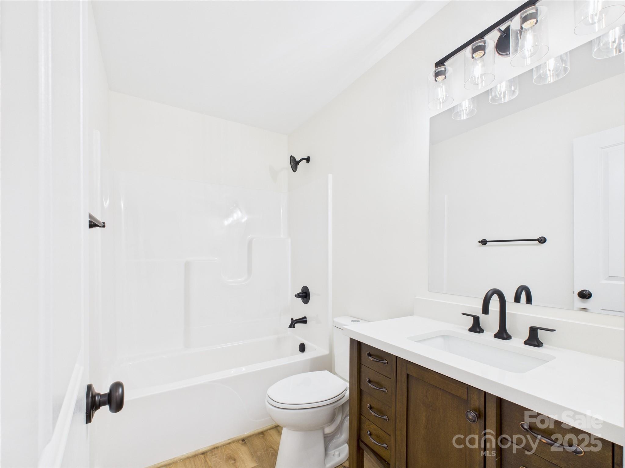3016 Icard Rhodhiss Road Connelly Springs, NC 28612 - Photo 8 of 20 a bathroom with a granite countertop sink a toilet and shower