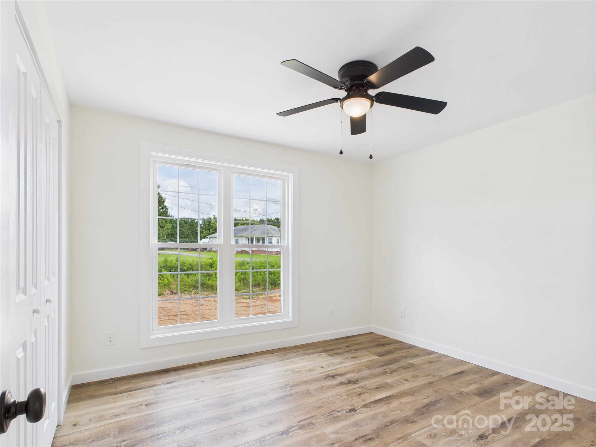 3016 Icard Rhodhiss Road Connelly Springs, NC 28612 - Photo 9 of 20 a view of empty room with wooden floor and fan