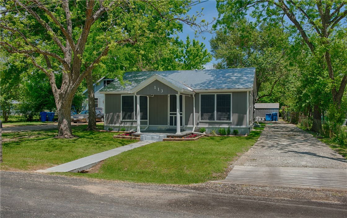 113 Ila Street Elgin, TX 78621 - Photo 1 of 1 a front view of a house with a yard table and chairs