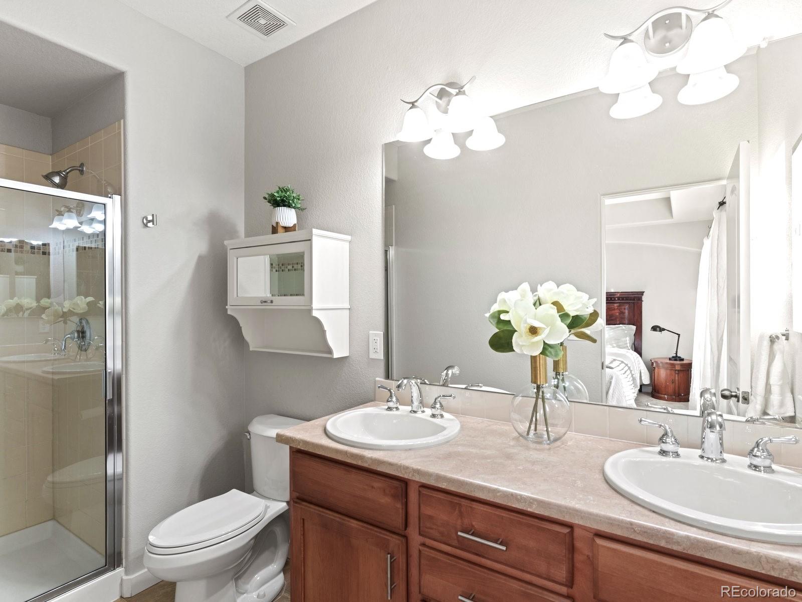 2230 Valentia Street Denver, CO 80238 - Photo 12 of 18 a bathroom with a granite countertop sink a toilet and a mirror