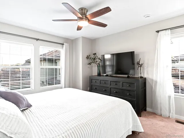 a bedroom with a large bed and a flat screen tv