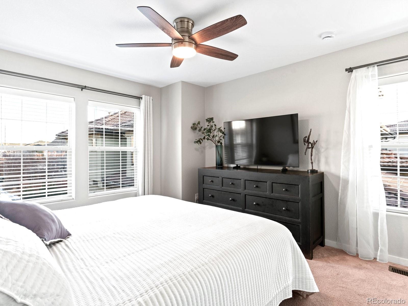 2230 Valentia Street Denver, CO 80238 - Photo 14 of 18 a bedroom with a large bed and a flat screen tv