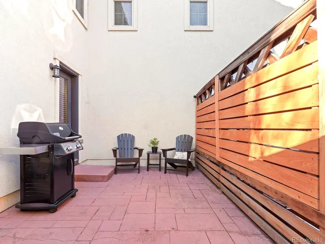 a sitting area with barbeque area in front of it