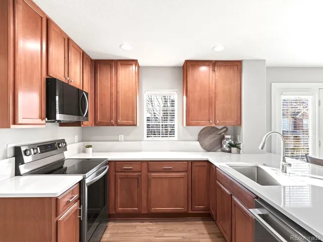 a kitchen with a sink a stove and cabinets