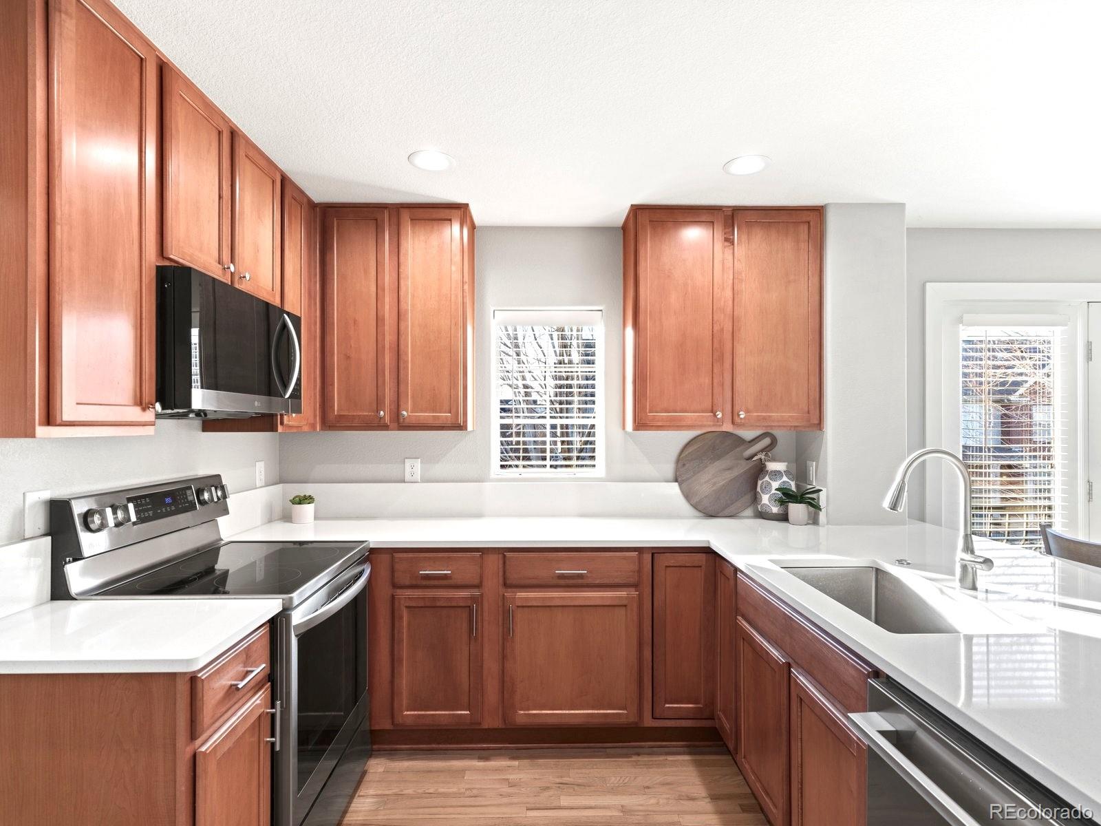 2230 Valentia Street Denver, CO 80238 - Photo 4 of 18 a kitchen with a sink a stove and cabinets