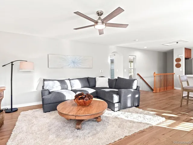 a living room with furniture and a wooden floor