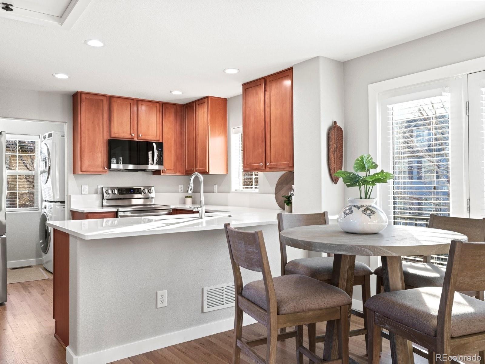 2230 Valentia Street Denver, CO 80238 - Photo 9 of 18 a kitchen with a table chairs microwave and cabinets