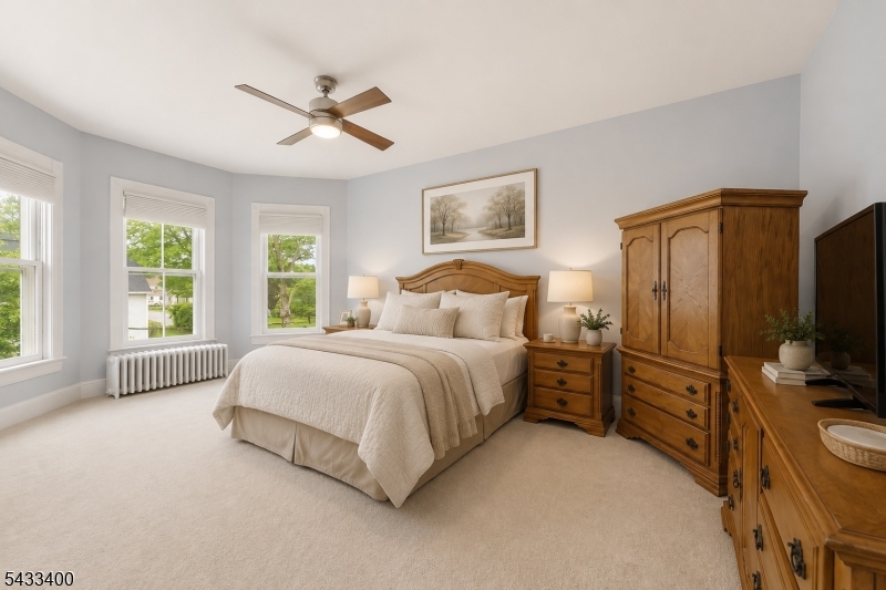 61 New Street Hampton, NJ 08827 - Photo 29 of 45 a spacious bedroom with a bed and a flat screen tv