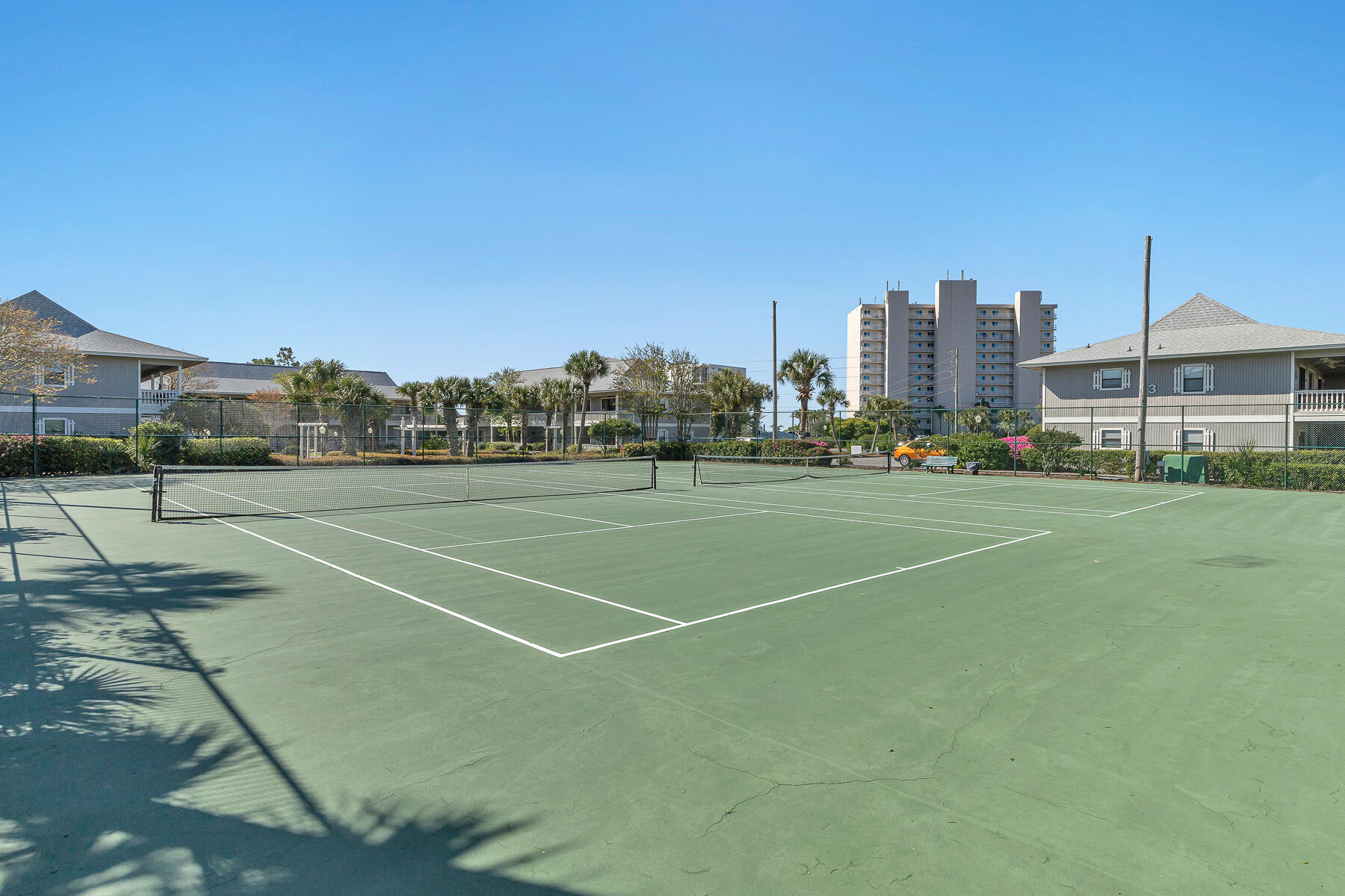 3799 East County Highway 30A, Unit D10 Santa Rosa Beach, FL 32459 - Photo 18 of 42 a view of a tennis ground with large trees