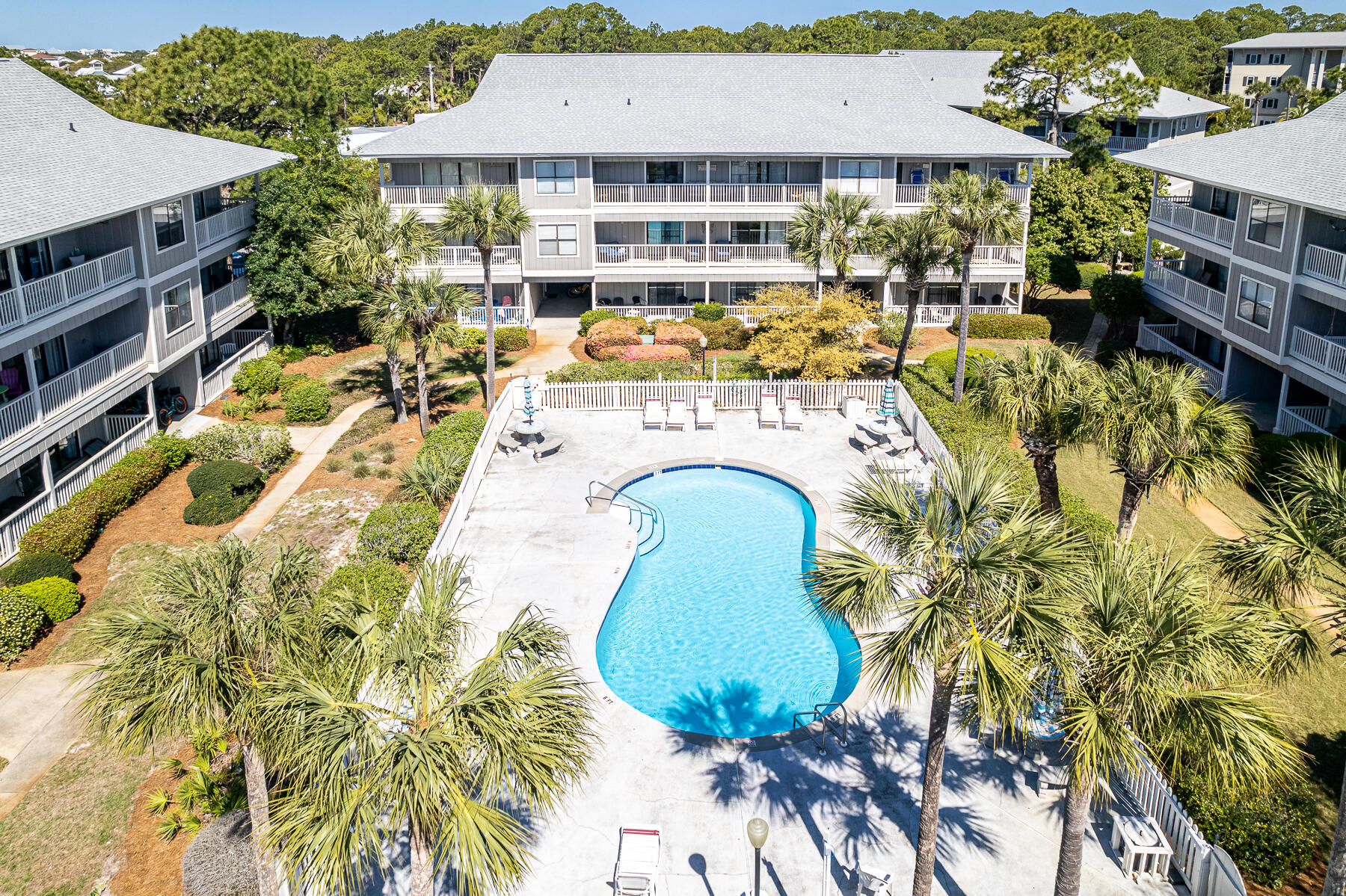 3799 East County Highway 30A, Unit D10 Santa Rosa Beach, FL 32459 - Photo 2 of 42 a view of a swimming pool with a patio and a garden