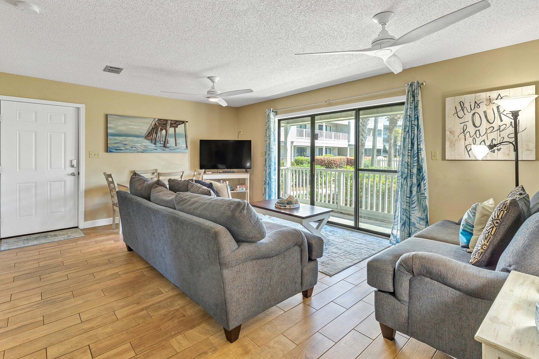 3799 East County Highway 30A, Unit D10 Santa Rosa Beach, FL 32459 - Photo 22 of 42 a living room with furniture floor to ceiling window and a flat screen tv