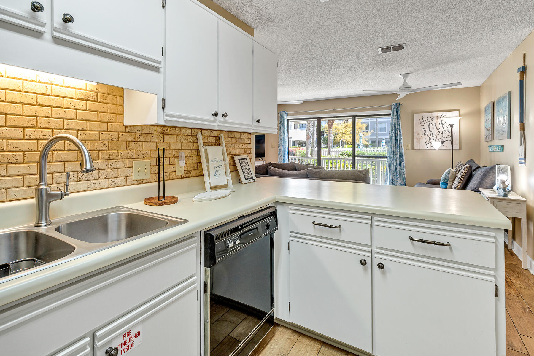 3799 East County Highway 30A, Unit D10 Santa Rosa Beach, FL 32459 - Photo 27 of 42 a kitchen with white cabinets sink and appliances